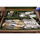 AN OAK CANTEEN CASE containing a quantity of silver plated cutlery