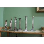 A PAIR OF SILVER PLATED CANDLESTICKS of Corinthian column form, each 25cm in height, a pair of Art