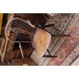 AN ANTIQUE WINDSOR ARMCHAIR, the pierced splat with fleur de lys decoration, 56cm wide x 81cm high