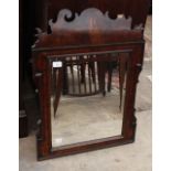 AN EARLY GEORGIAN WALNUT FRET CARVED MIRROR with bevelled edge mirror plate 73cm x 54.5cm