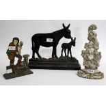 THREE PAINTED CAST IRON DOOR STOPS, one in the form of a donkey, one of a musical man and one