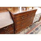 A 19TH CENTURY OAK CHEST OF TWO SHORT AND THREE LONG DRAWERS with brass swan neck handles and raised