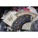 AN ANTIQUE LADIES FOLDING FAN, the leaf decorated to both sides with hand coloured print of