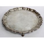A SHEFFIELD SILVER SERPENTINE EDGE SALVER standing on ball and claw feet, engraved with initial '