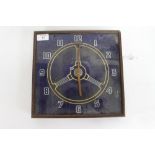 A REVERSE PRINTED GLASS CLOCK depicting an automobile steering wheel and having Arabic numerals 29cm