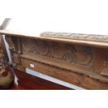 AN ANTIQUE PINE FIRE SURROUND with carved acanthus leaf decoration, 175cm wide x 124cm high