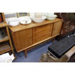 A GORDON RUSSELL OF BROADWAY TEAK SIDEBOARD with three central drawers and cupboards to either side,