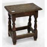 AN ANTIQUE OAK JOINT STOOL with rectangular top and turned legs united by stretchers, 47cm wide x