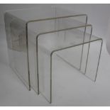 A NEST OF THREE CLEAR PERSPEX TABLES, the largest 41cm wide x 40cm high