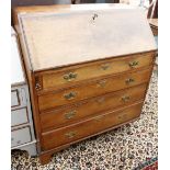 A GEORGE III MAHOGANY BUREAU, the fall front enclosing a fitted interior over four long drawers