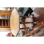 A VICTORIAN OCTAGONAL LOW TABLE with galleried under tier on turned legs, standing on brass casters,