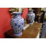 A PAIR OF MODERN BLUE AND WHITE BALUSTER VASES with flared rims, decorated with scenes of flowers