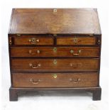 A GEORGE III MAHOGANY BUREAU, the fall front enclosing a fitted interior with drawers, pigeon