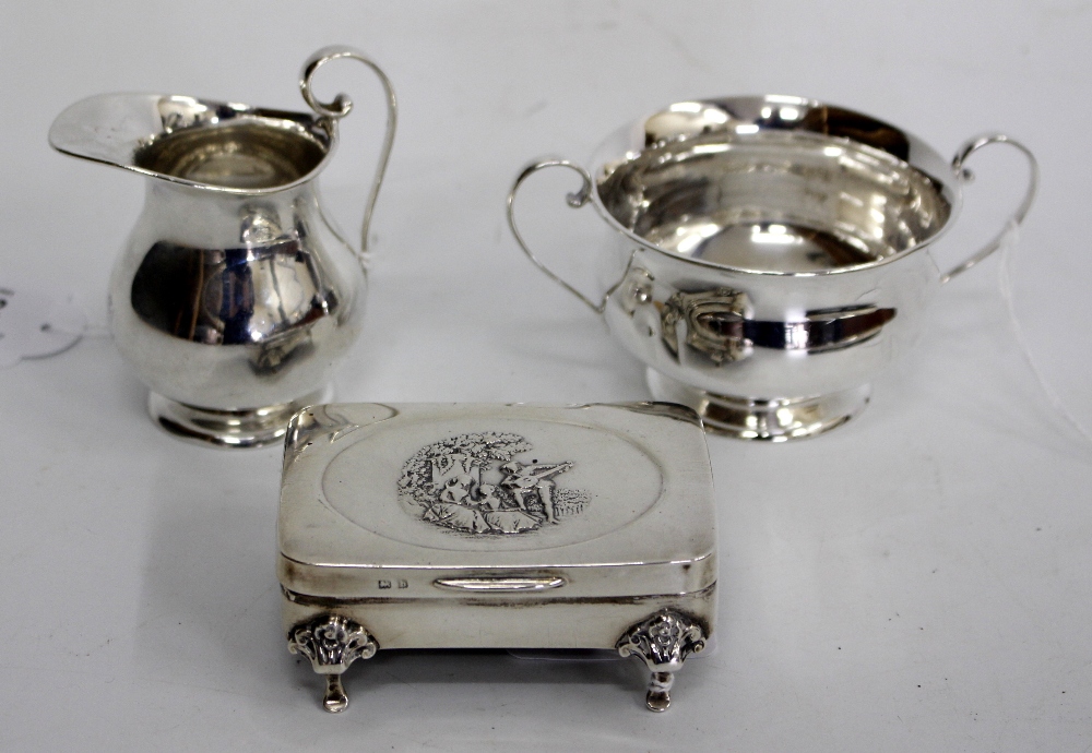 A BIRMINGHAM SILVER TWIN HANDLED BOWL on pedestal base a matching jug, and an antique velvet lined