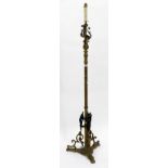A VICTORIAN BRASS LAMP STANDARD on reeded stem and figural cherubs applied to the base, 178cm high