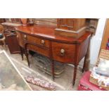 A GEORGE III FLAME MAHOGANY BOW FRONTED SIDE BOARD with lion mask handles, standing on turned legs