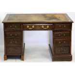 AN OAK PEDESTAL DESK with a brown leather inset top 121cm wide x 65cm deep