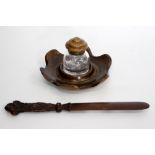 A TREEN AND GLASS INKWELL with stand, 20cm diameter together with a Black Forest letter opener