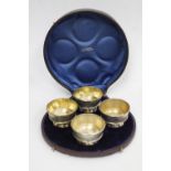 A BOXED SET of four Victorian Sheffield silver salts with gilt lined interior and engraved