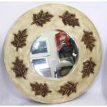 A CONTEMPORARY CIRCULAR WALL MIRROR, the painted frame moulded with leaves, 100cm diameter