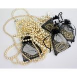 A GROUP OF FAUX PEARL NECKLACES of varying sizes and styles