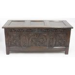 AN 18TH CENTURY OAK CARVED PANEL COFFER standing on stile feet 133cm x 60cm x 57cm