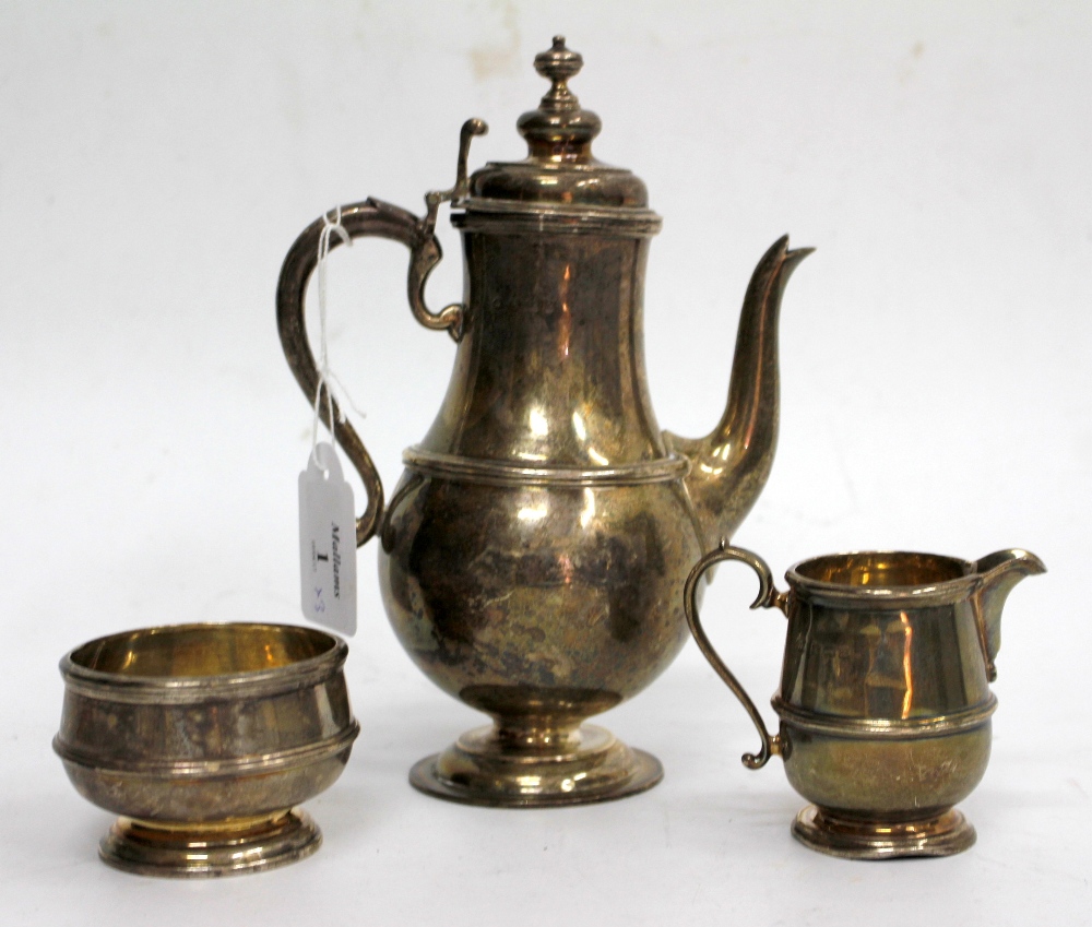 A SILVER COFFEE POT of baluster form, 20cm high together with a matching sugar bowl and cream jug (