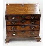 A GEORGE III MAHOGANY BUREAU the fall front opening to reveal drawers and pigeon holes, all above