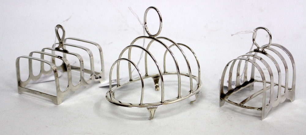 THREE SILVER TOAST RACKS, two of which are a matching pair, the other by Walker and Hall (3)