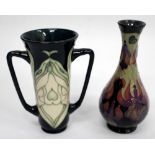 A CONTEMPORARY LATE 20TH / EARLY 20TH CENTURY MOORCROFT TAPERED VASE decorated in trailing