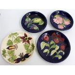 FOUR LATE 20TH / EARLY 21ST CENTURY MOORCROFT PLATES on blue and cream ground, the largest 25cm
