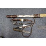 AN AFRICAN PANGA with leather scabbard and a whip and further small knives