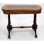 A VICTORIAN WALNUT AND BOXWOOD INLAID FOLD OVER CARD TABLE with turned supports and scrolling legs