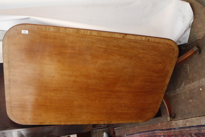 A 19TH CENTURY MAHOGANY AND SATINWOOD CROSS BANDED TILT TOP TABLE, the top 130cm x 81cm