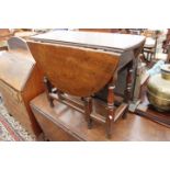 AN 18TH CENTURY OAK GATELEG TABLE standing on turned legs, 82cm x 66cm