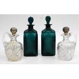 A PAIR OF GEORGIAN BRISTOL GREEN GLASS SPIRIT DECANTERS one engraved Brandy, the other Rum, each