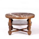 AN EARLY 20TH CENTURY CIRCULAR OAK LOW CENTRE TABLE with marble inset top, the turned legs with an