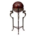 A DECORATIVE ROMAN INSPIRED FLOOR LAMP with spherical shade on a bronzed stand with cast leopard's