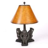 A BRONZED TABLE LAMP with conical shade, the base set with three monkeys, 67cm high