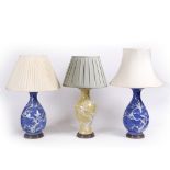 A GROUP OF THREE VARIOUS PORCELAIN TABLE LAMPS of baluster form, each with white glaze decoration of