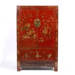A CHINESE RED LACQUERED CABINET the doors decorated with exotic birds enclosing shelves and