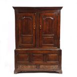 AN 18TH CENTURY WELSH OAK PRESS CUPBOARD with panelled doors above a recessed base with panelled
