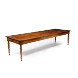A LARGE ANTIQUE FRENCH FRUITWOOD FARMHOUSE TABLE the plank top with cleated ends standing on turned,