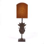 A CONTEMPORARY TABLE LAMP with faux leather shade and with shell cast bronze stem and on a plinth