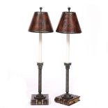 A PAIR OF TABLE LAMPS with faux leather shades, the stems in the form of Corinthian columns and