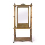 A BRASS HALL STAND with bevelled mirror plate, turned columns and paw feet, 96cm wide x 208cm high