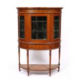 AN EARLY 20TH CENTURY BOW FRONTED SATINWOOD DISPLAY CABINET with decorative inlay, central drawer