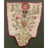 A 18TH CENTURY CREWEL WORK EMBROIDERED STOMACHER decorated with flowers and birds, 23cm x 29cm and