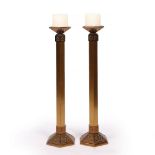 A PAIR OF BRASS HEXAGONAL LARGE CANDLESTICKS with stylised flower decoration to the frieze and
