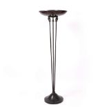 A FLOOR STANDING LAMP with spreading faux tortoiseshell shade on a support surmounted by cast horses